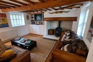 a living room with a large dog laying on a couch at Wellow Farmhouse in Wellow