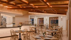 a restaurant with wooden tables and chairs and a kitchen at Park Royal Beach Acapulco - All Inclusive in Acapulco