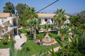an aerial view of a resort with palm trees at Ilios Hotel, Adults Only in Laganas