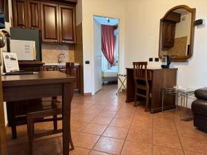 a kitchen and a living room with a table and chairs at EURO HOUSE INN airport in Fiumicino
