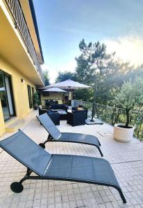a group of chairs sitting on a patio at Casa Picone - Gerês in Ventosa