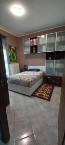 a bedroom with a bed and a desk in it at Ca'Nostra in Bagnolo Piemonte