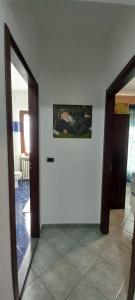 a hallway with two doors and a painting on the wall at Ca'Nostra in Bagnolo Piemonte