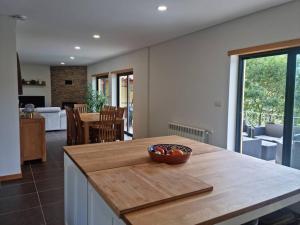 a kitchen with a bowl of fruit on a counter at Casa Picone - Gerês in Ventosa +34 photos