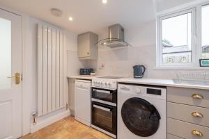 a kitchen with a washing machine and a window at Luxury 1 bed Apartment in Portadown +13 photos