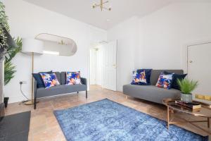 a living room with two couches and a blue rug at Luxury 1 bed Apartment in Portadown