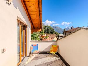 a balcony with chairs and a view of the mountains at Holiday Home Marino by Interhome in Cima