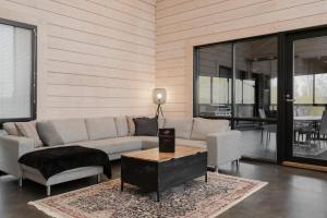 a living room with a couch and a table at Villa Nevada - 10+2 henkilölle, Luoteis-Himos Ski-in/out, 255m² in Jämsä