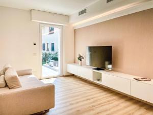 a living room with a couch and a flat screen tv at Holiday Home Allegra by Interhome in Dervio