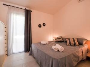 a bedroom with a bed with two towels on it at Holiday Home Mirto Marino-2 by Interhome in Costa Rei