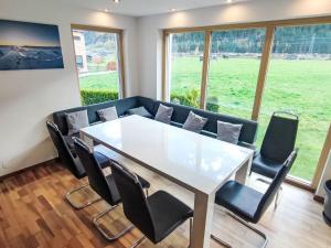 a conference room with a white table and chairs at Apartment Bella Monte-5 by Interhome in Pettneu am Arlberg
