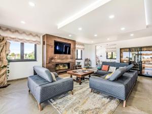 a living room with two couches and a fireplace at Villa Flor de Lis - VIP Properties by Interhome in Paderne