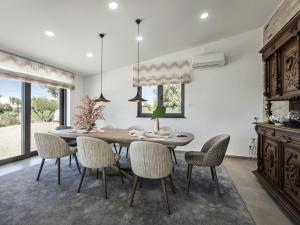 a dining room with a table and chairs at Villa Flor de Lis - VIP Properties by Interhome in Paderne