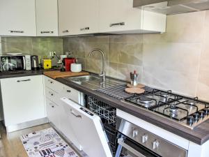 a kitchen with a stove and a sink at Apartment La Conca by Interhome in Formia