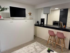 a kitchen with a bar with a tv on top of it at Estudio centrico de lujo in Vigo +27 photos