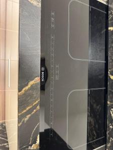 a glass door with a remote control on it at Estudio centrico de lujo in Vigo