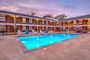 a swimming pool in front of a hotel at The Guest Lodge Gainesville in Gainesville