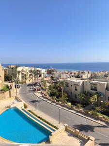 a view of a city with a swimming pool and the ocean at Roof top apartment with panorama view in Hurghada