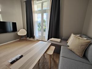 a living room with a couch and a large window at Evje Park in Evje