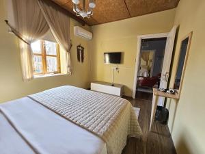 a bedroom with a white bed and a window at Burcu Guest Home in Çağlayan