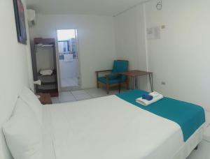 Voodi või voodid majutusasutuse Galápagos Isabela Hotel Loja toas