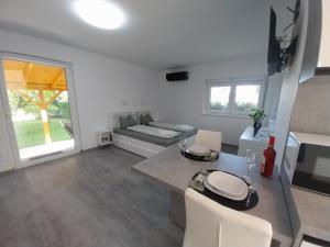 a living room with a table and a couch at RELAX INN Harkány in Harkány