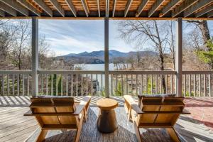 a porch with two chairs and a view of a lake at Lakeside Serenity Mnt Views Decks Foosball in Lake Lure