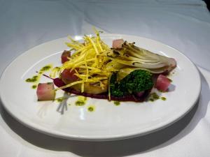 a plate of food with broccoli and cheese on it at The Teesdale Hotel in Middleton in Teesdale