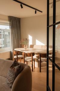 a living room with a couch and a table at Design appartement op toplocatie in Knokke in Knokke-Heist