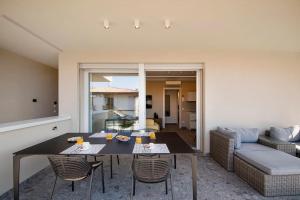 a living room with a table and a couch at Luxury House - Small Heated Pool in Bardolino