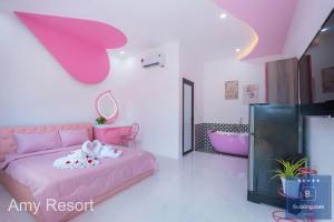 a pink bedroom with a pink bed and a tub at Amy Resort Pool Party - Đi Bộ Ra Biển - Thích Hợp Tổ Chức Tiệc Team Building in Vung Tau