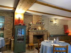 a restaurant with a fireplace and a table in a room at 8 rooms in Mtskheta