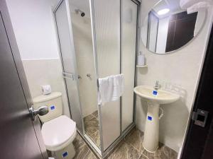a small bathroom with a toilet and a sink at Castellana 201-Apartaestudio en la Castellana con espacio trabajo in Armenia +6 photos