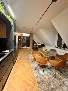 a living room with a table and chairs at Ylly aparts in Braşov