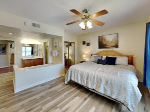 a bedroom with a bed and a bathroom with a tub at Paradise Pines Whispering Pines 133 in Pigeon Forge