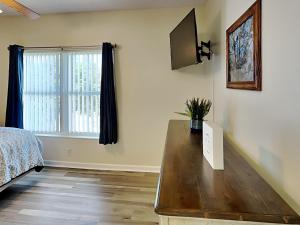 a bedroom with a bed and a tv on the wall at Paradise Pines Whispering Pines 133 in Pigeon Forge
