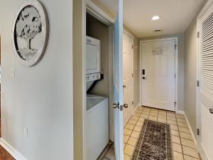 a kitchen with a white stove top oven next to a door at Paradise Pines Whispering Pines 133 in Pigeon Forge +14 photos