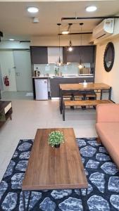 a living room with a table and a kitchen at Cyberjaya Studio Suite By NSB in Cyberjaya