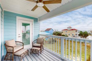a porch with two chairs and a ceiling fan at Bahia Beauty - 3rd Floor in Navarre
