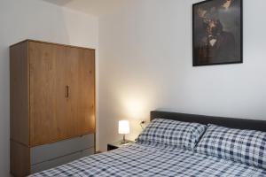 a bedroom with a bed and a dresser and a cabinet at Annì in Temù