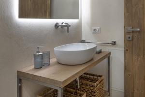 a bathroom with a large white bowl sink on a counter at Annì in Temù