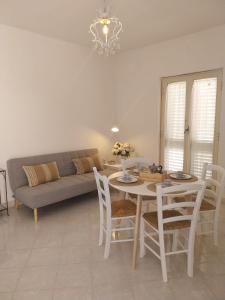 a living room with a table and a couch at Casa Sisina in Capri