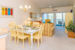 a dining room and living room with a table and chairs at Lakefront and 1 Block to Beach! Walk to Main St in Myrtle Beach