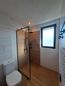 a bathroom with a shower with a toilet and a window at 3-Bedroom Villa in Lozenets, Burgas, Bulgaria in Lozenets +16 photos