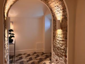 an archway in a room with a stone wall at Luxurious 2 bedroom apartment with sea view in Monkstown in Blackrock