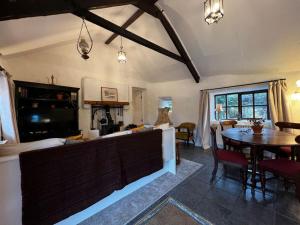 a living room with a table and a dining room at Private Thatched Cottage - with views in Letterkenny