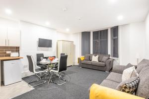 a living room with a couch and a table at Velvet Coaster Apartments in Blackpool