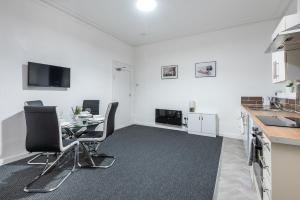 a kitchen and dining room with a table and chairs at Velvet Coaster Apartments in Blackpool