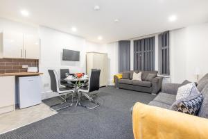 a living room with a couch and a table at Velvet Coaster Apartments in Blackpool