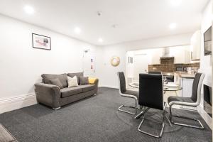 a living room with a couch and a table and chairs at Velvet Coaster Apartments in Blackpool